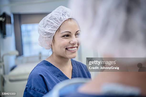 young female surgeon in hospital smiling, candid portrait - hospital selective focus stock pictures, royalty-free photos & images