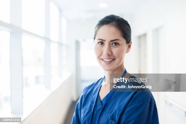 female asian nurse smiling towards camera, portrait - smiling nurse stock pictures, royalty-free photos & images