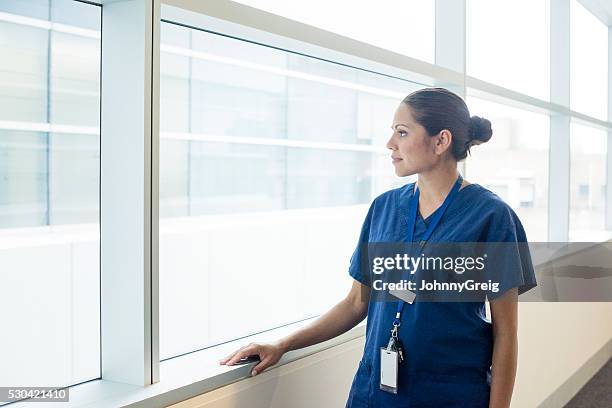 aboriginal australian doctor looking through hospital window - asian tribal culture stock pictures, royalty-free photos & images