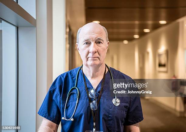 senior medical professional in hospital building, portrait - determination doctor stock pictures, royalty-free photos & images