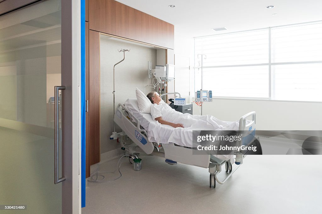 Woman lying in bed on hospital ward