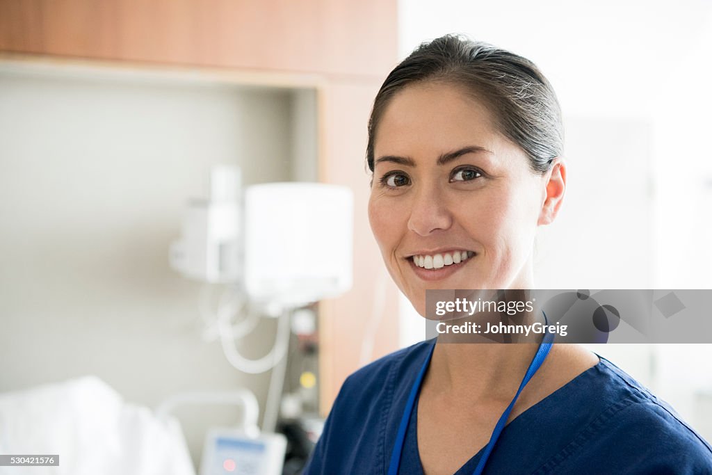 Portrait of mid adult Asian nurse smiling towards camera