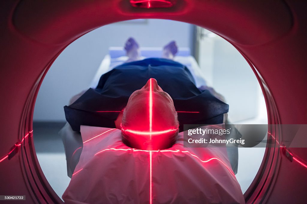 Male patient in medical scanner with red lights