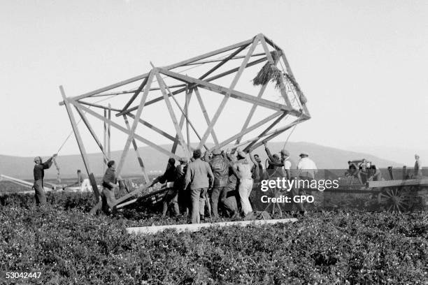 Zionist Jewish volunteers raise a watch tower as they establish in a one-day operation the "Tower and Stockade" pioneering cooperative community...