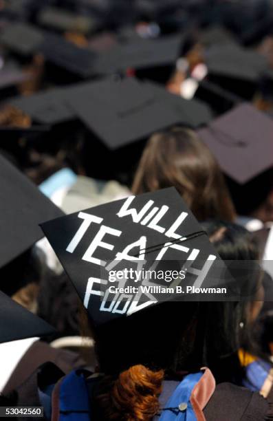 Graduate of Harvard's Graduate School of Education wears a mortar board which reads, "Will Teach 4 Food" during Harvard University Commencement...