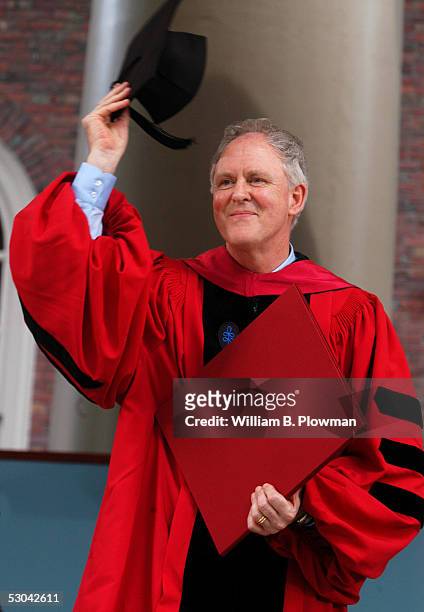 Actor John Lithgow tips his mortar board to the crowd after being awarded an honorary degree at the Harvard University Commencement exercises June 9,...