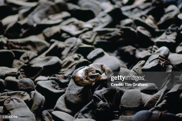 Majdanek Concentration Camp - a child's shoe lies among shoes discarded from Jewish victims of the Holocaust, Poland.