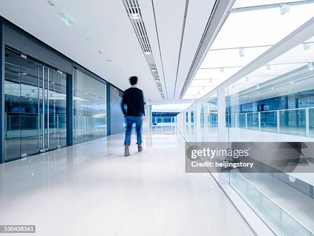 young aisian businessman walking in architecture - asian ceiling stock pictures, royalty-free photos & images