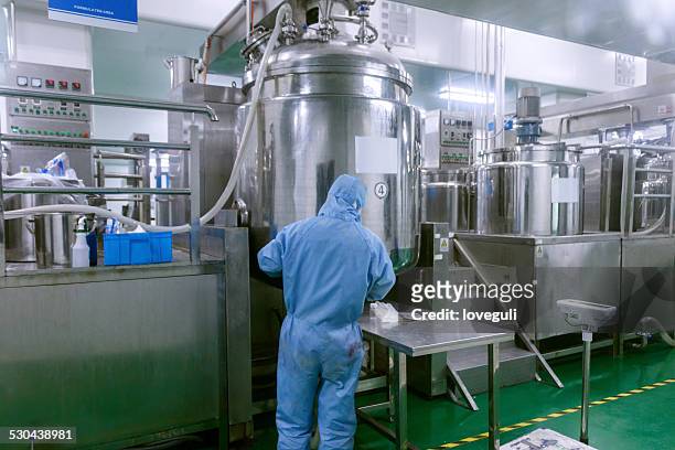 technician check manufacture equipment and reactors in pharmacy factory - manufacturing stock pictures, royalty-free photos & images