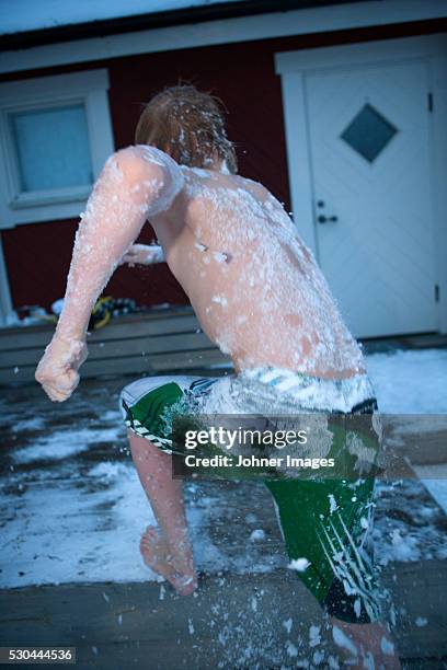 shirtless boy covered in snow - zwembroek stockfoto's en -beelden