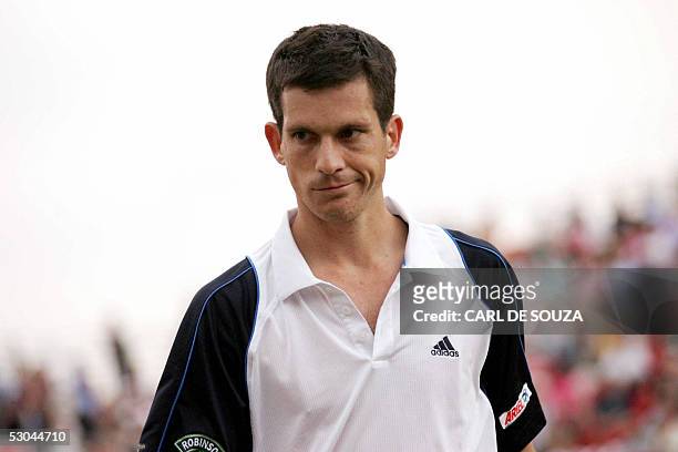 London, UNITED KINGDOM: British player Tim Henman walks off after beating Australian Chris Guccione at Queens Tennis club on the fourth day of the...