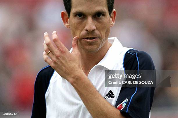 London, UNITED KINGDOM: British player Tim Henman walks off after beating Australian Chris Guccione at Queens Tennis club on the fourth day of the...