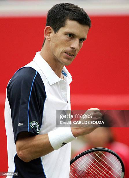 London, UNITED KINGDOM: British player Tim Henman celebrates after beating Australian Chris Guccione at Queens Tennis club on the fourth day of the...