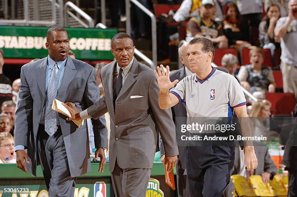 Seattle SuperSonics coach Nate McMillan and assistant Dwane Casey speak with referee Joe Forte during play against the San Antonio Spurs in Game 6 of...