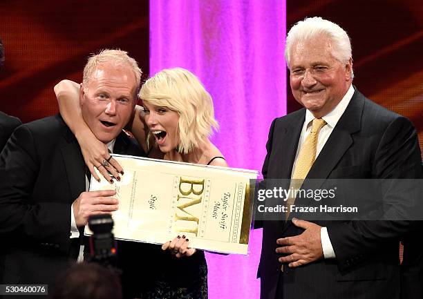 President/CEO of Sony/ATV Music Publishing Nashville Troy Tomlinson, honoree Taylor Swift, and Sony/ATV CEO Martin Bandier pose with award onstage at...