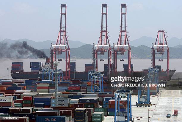 Container ship is loaded while docked at Ningbo Port, 09 June 2005, in China's southeastern Zhejiang province. Located in the middle of China's...