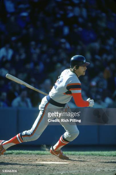 Carlton Fisk of the Chicago White Sox heads toward first as he watches the flight of his hit during a game at Fenway Park in Boston, Massachusetts....