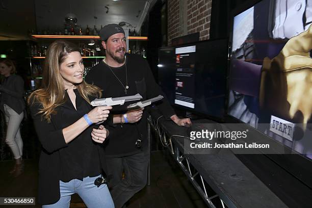 Actors Ashley Greene and Tanner Beard play 6 Bullets to Hell at the "6 Bullets To Hell" Mobile Game Launch Party on May 10, 2016 in Los Angeles,...