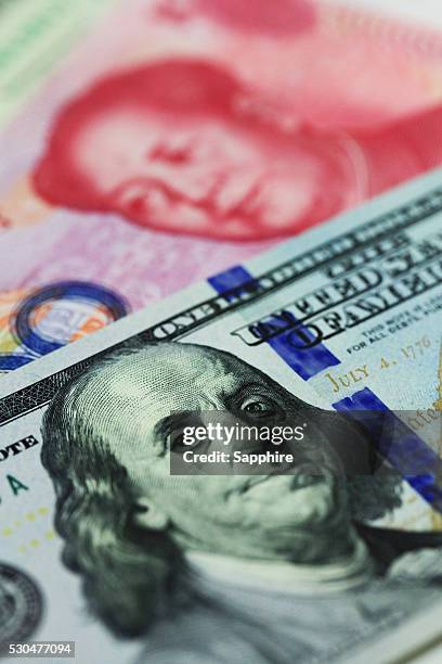 chinese currency note and us dollar - yuan symbol stock-fotos und bilder