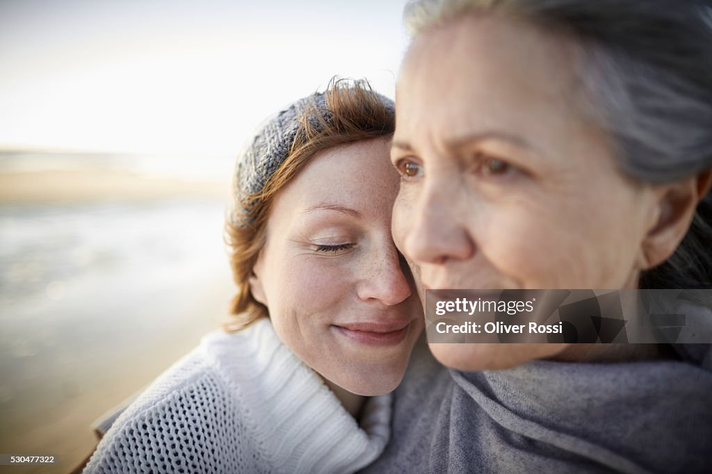 Mother and adult daughter on beach