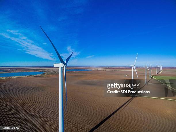 row of wind turbines against blue sky - texas farm stock pictures, royalty-free photos & images