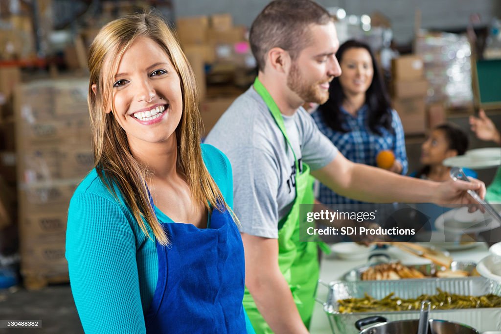 Volunteers serves food at soup kitchen