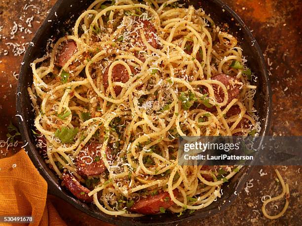 spaghetti aglio e olio with sausage and parmesan - fettuccine alfredo stock pictures, royalty-free photos & images