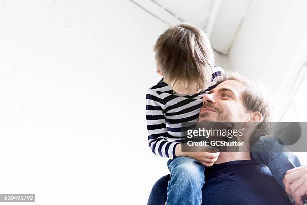 awww father and son having fun - family hugging bright stock pictures, royalty-free photos & images