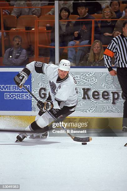 Canadian hockey player Wayne Gretzky of the L.A. Kings controls the puck during a game at the Great Western Forum, Los Angeles, California, February...