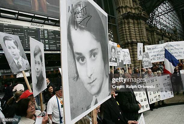 Demonstrators display pictures of Jewish children at Frankfurt's main train station on June 10, 2005 in Frankfurt, Germany. During World War II the...