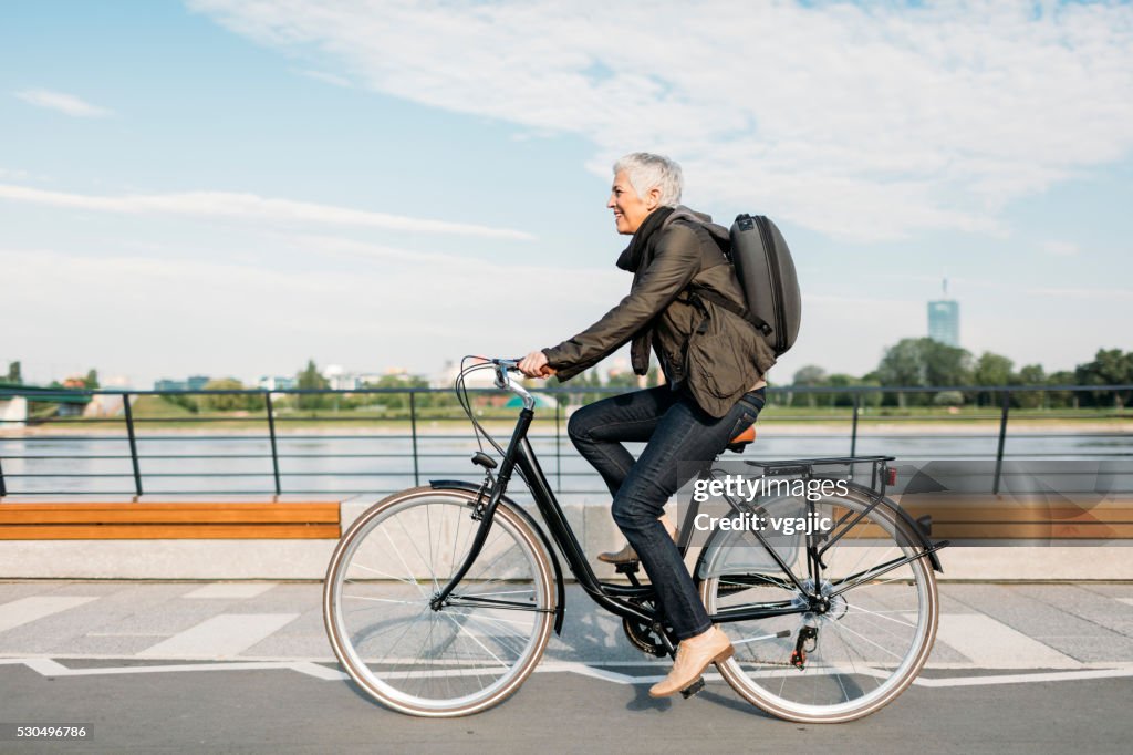 Mature Woman Riding Bicycle.