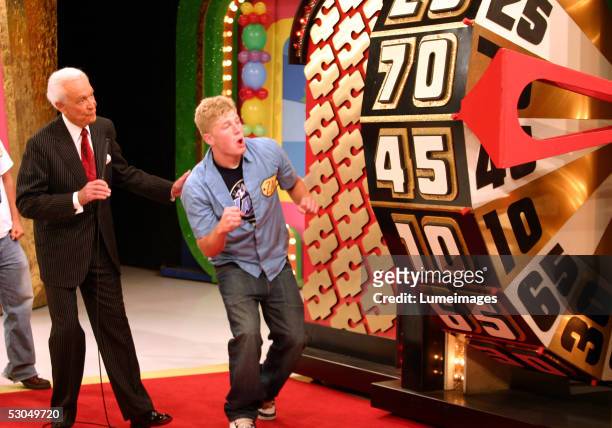 Bob Barker looks on as a contestant takes part in a game during the taping of the 34th season premiere of "The Price is Right" at CBS Television City...