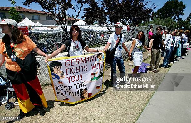 Michael Jackson fan Bianca Schmidt links hands with other fans out front the courthouse as they wait for a verdict in the Michael Jackson child...