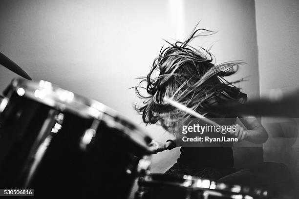 girl playing rock and roll drums - black and white stock pictures, royalty-free photos & images
