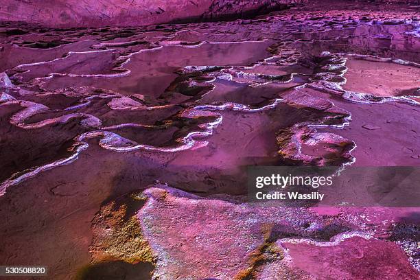 Violet ice cave covered with snow and flooded