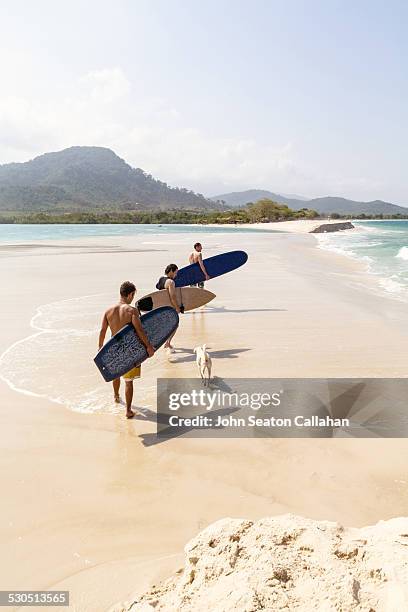 surfers on the beach at river number 2 - sierra leone beach stock pictures, royalty-free photos & images