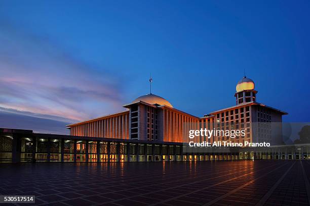 istiqlal mosque with dramatic sunset in jakarta with lights on - istiqlal stock pictures, royalty-free photos & images