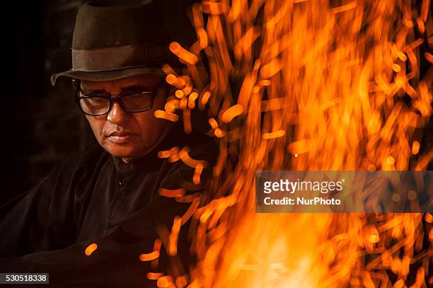 Ki Empu Sungkowo iron burn when making kris in Gatak Village, Yogyakarta, Indonesia, on May 10, 2016. Art Wrought Kris Ki Empu Sungkowo since 1995...