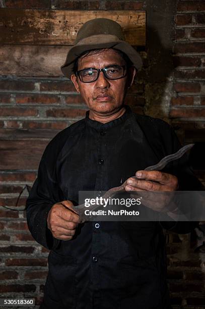 Ki Empu Sungkowo pose when after making the kris in Gatak Village, Yogyakarta, Indonesia, on May 10, 2016. Art Wrought Kris Ki Empu Sungkowo since...