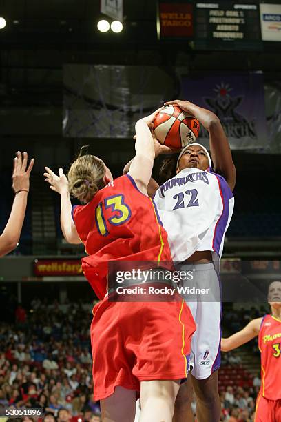 DeMya Walker of the Sacramento Monarchs drives to the basket against Penny Taylor of the Phoenix Mercury during the game on June 10, 2005 at Arco...