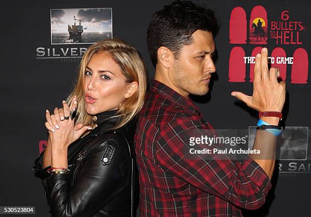 Actors Cassie Scerbo and Redford attends the launch of "6 Bullets To Hell" the video game and the movie on May 10, 2016 in Los Angeles, California.