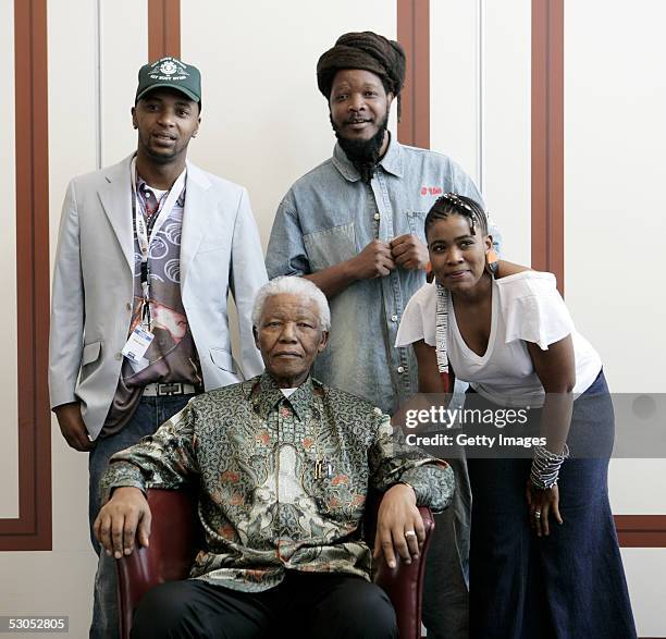 Artists, members of Bongo Maffin, Tshepo Seate , Adrian Mupemhi and Thandiswa Mazwai pose with Nelson Mandela at a photocall ahead of tonight's...