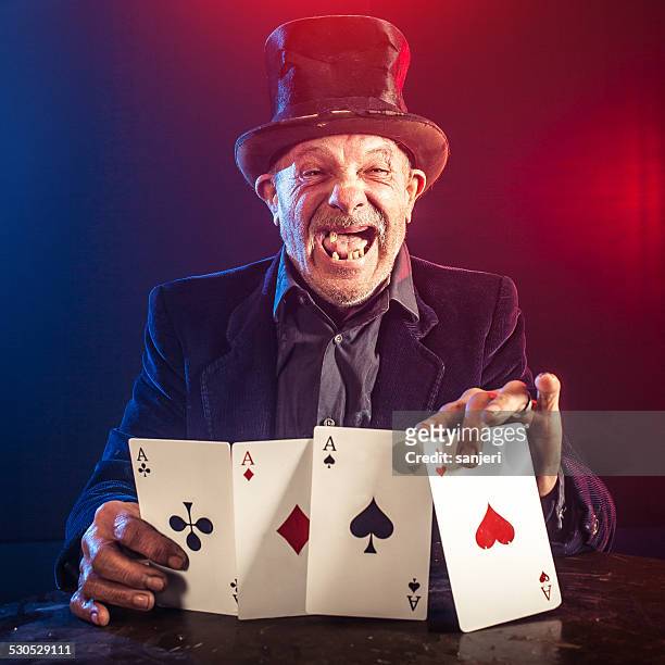 senior man making trick with playing cards - magician cards stock pictures, royalty-free photos & images
