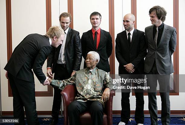 Artists the Kaizers Orchestra pose with Nelson Mandela at a photocall ahead of tonight's "46664 Arctic" concert, at the Rica Hotel on June 11, 2005...