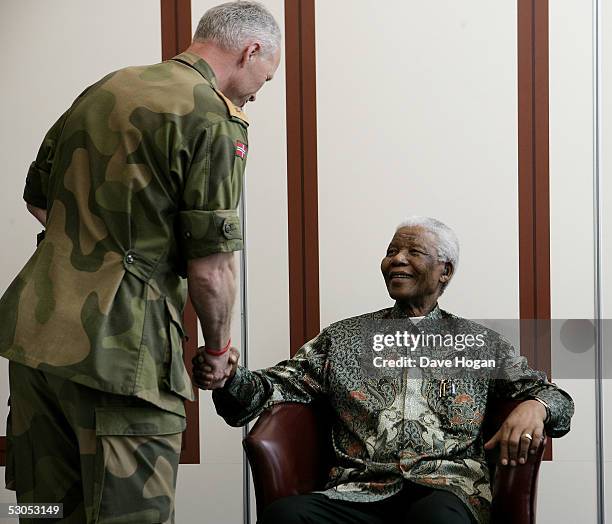 Major General Robert Mood of the Norwegian Army meets Nelson Mandela at a photocall ahead of tonight's "46664 Arctic" concert, at the Rica Hotel on...
