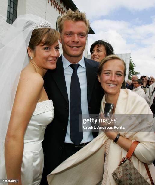 Bride Alexandra Stich , Oliver Geisen , TV-Moderator and his wife Ulrike poses for photograph at the Sankt Severin church on June 11, 2005 at Sylt,...