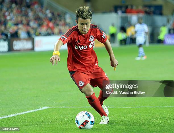 Tsubasa Endoh of Toronto FC dribbles the ball during the second half of an MLS soccer game against FC Dallas at BMO Field on May 7, 2016 in Toronto,...