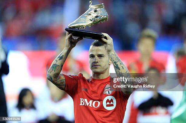 Sebastian Giovinco of Toronto FC is presented with the MLS Audi Golden Boot Award as leading scorer for the 2015 season prior to an MLS soccer game...