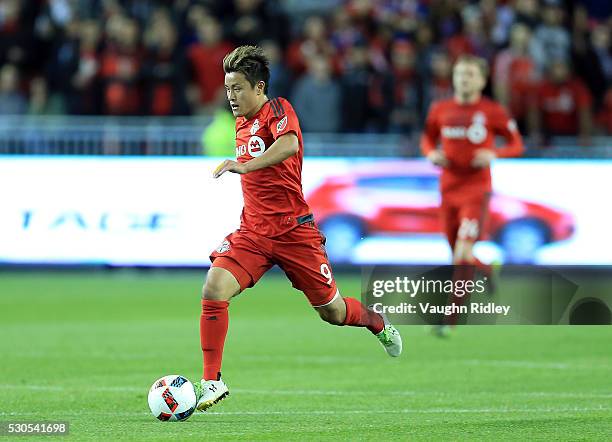 Tsubasa Endoh of Toronto FC dribbles the ball during the first half of an MLS soccer game against FC Dallas at BMO Field on May 7, 2016 in Toronto,...