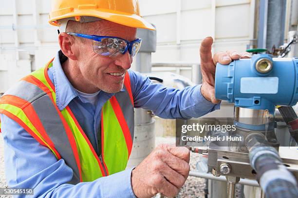 engineer at electric power plant examining a transducer - transducer stock pictures, royalty-free photos & images